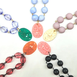 Collection of colorful beaded necklaces on a white background