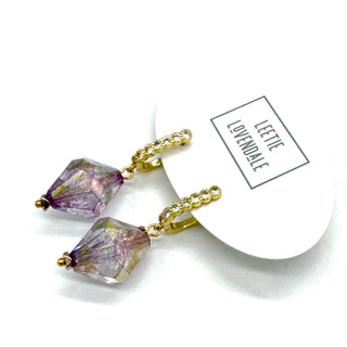 Purple crystal earrings with gold accents on a white background, featuring a 'Lavender' tag.