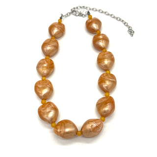 Necklace with brown baroque pearls on a white background