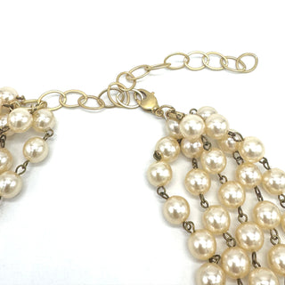 Pearl necklace with gold chain on a white background