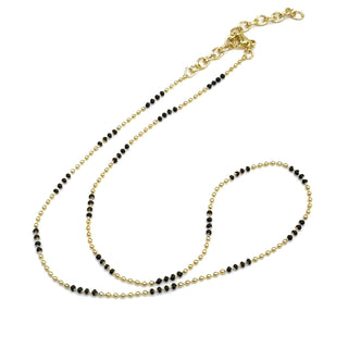 Two beaded necklaces, one gold and one black, on a white background.