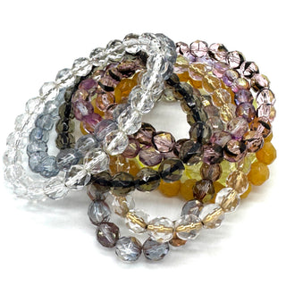 Set of multicolored beaded bracelets on a white background