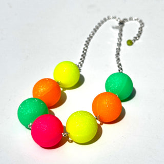 Colorful neon ball necklace on a white background