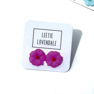 Pink flower-shaped earrings on a Leetie Lovendale branded card.