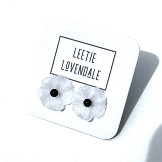White flower-shaped earrings on a white card with 'Leetie Lovendale' branding.