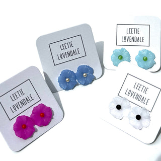 Set of floral earrings on display with 'Leetie Lovendale' packaging.