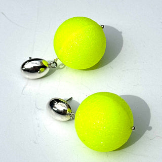 Pair of neon yellow ball earrings with silver posts on a white background