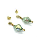 Gold earrings with green AB lucite drops on a white background