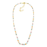 A golden chain necklace with colorful enameled links on a white background.
