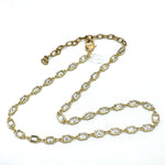 Gold chain necklace with clear stones on a white background