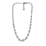 Silver necklace with clear stones on a white background