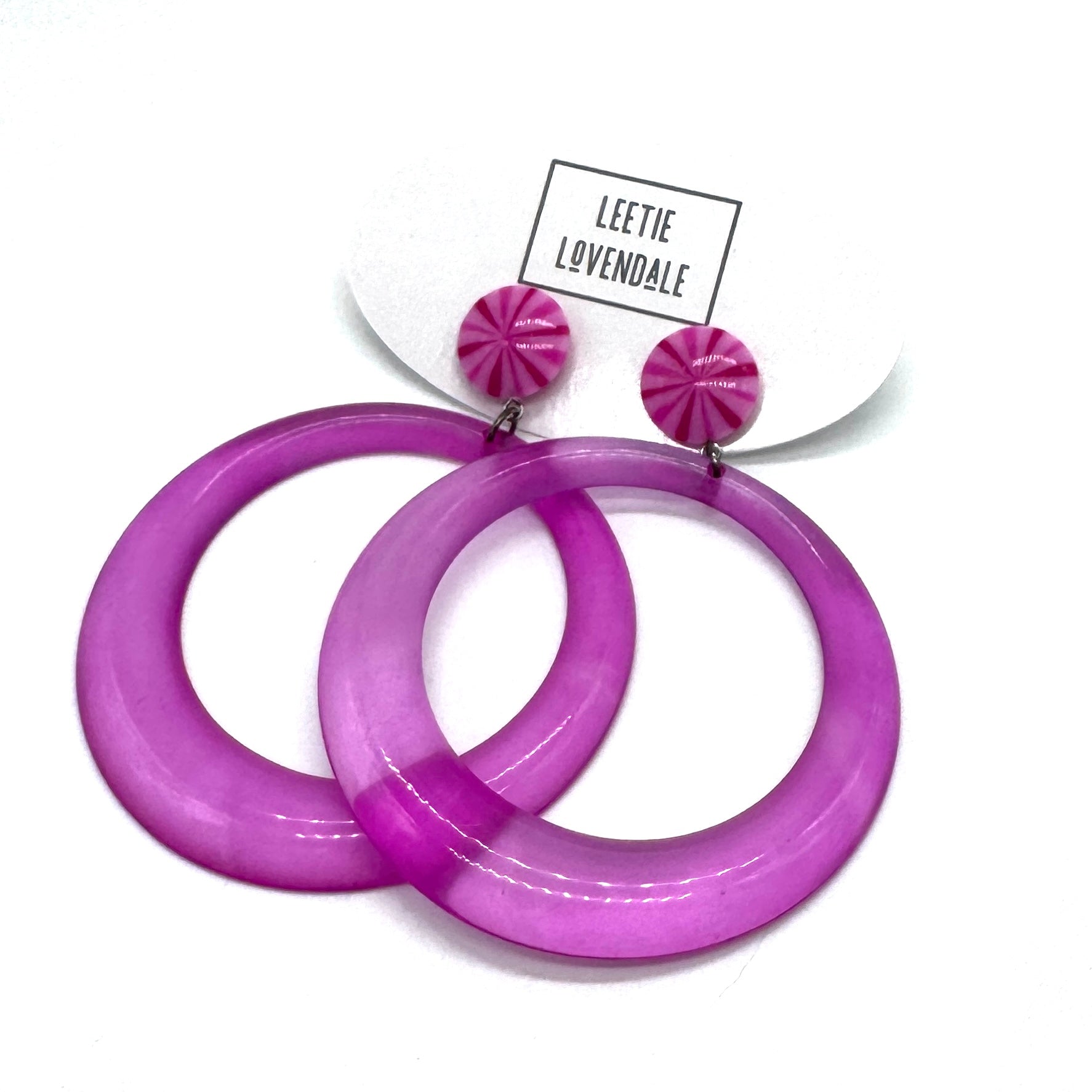 Purple hoop earrings with pink accents on a white background, featuring the brand 'Leetie Lovendale'.