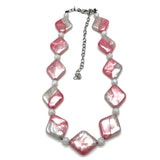 Necklace with pink and white beads on a white background