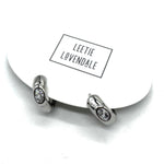 Silver and crystal hoop earrings on an earring card.
