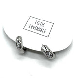 Silver and crystal hoop earrings on an earring card.