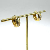 Gold hoop earrings with a crystal set in the center of each.
