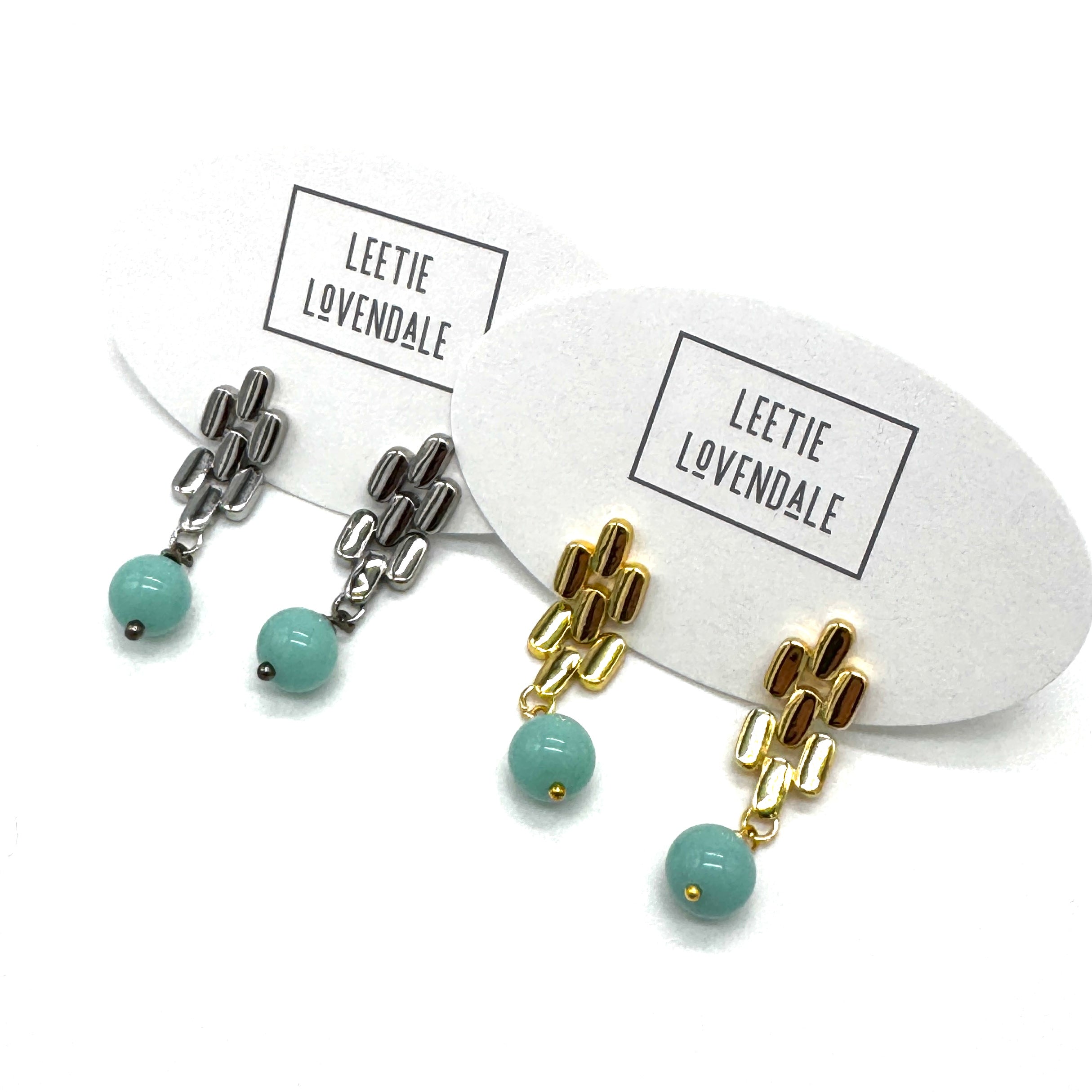 Silver and gold drop earrings with turquoise glass beads.
