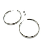 Large silver hoop earrings on a white background.
