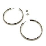 Large silver hoop earrings on a white background.