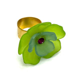 Lime and green floral cocktail ring on a white background.