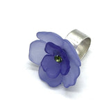 Perwinkle and purple floral cocktail ring on a white background.