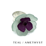 Floral cocktail ring on a white background labeled teal/amethyst.