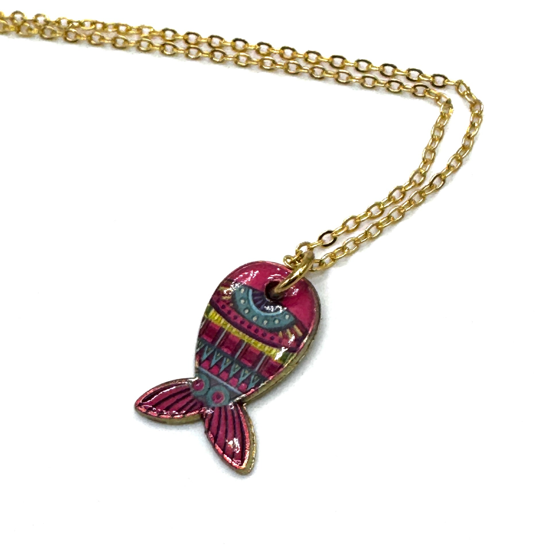 A gold chain necklace featuring a colorful fish-shaped pendant with pink, teal, and yellow patterns, set against a plain white background.