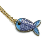 A gold chain necklace with a fish-shaped pendant featuring light blue and purple enamel scales, shown on a plain white background.