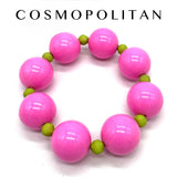 Pink and green beaded bracelet on a white background with 'Cosmopolitan' branding.