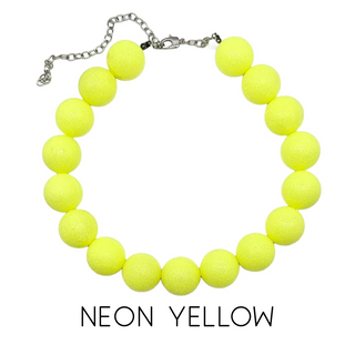 Neon yellow bead necklace on a white background