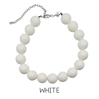 White beaded necklace on a white background with 'WHITE' text below.