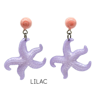 Pair of purple starfish-shaped earrings with pink tops on a white background