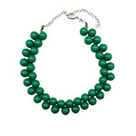 Opaque green beaded necklace on a white background.