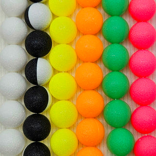 Colorful neon necklaces made with vintage lucite on a wooden background.