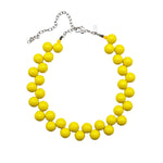 Yellow cluster beaded necklace on a white background.